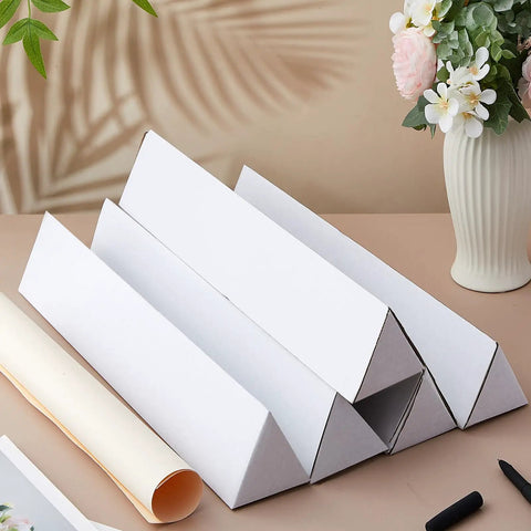 Tough Triangle Mailing Tubes 50 Pack Corrugated Cardboard Poster Tubes 36 Inch Long Oyster White on table with rolled paper.