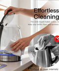 Person cleaning Electric Glass Kettle With Auto Shut Off 1.8L Borosilicate Glass Body Stainless Steel Inner Lid And Base No Plastic Touching Boiling Water Quick Boil Safe Pour Modern Countertop Tea And Coffee Kettle