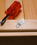 30 Pack Heavy Duty Double Wheel Curtain Track Pulleys on wooden surface next to a red screwdriver, highlighting sturdy design.