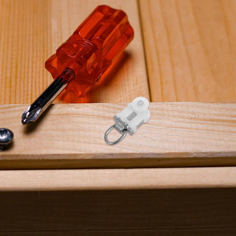 30 Pack Heavy Duty Double Wheel Curtain Track Pulleys on wooden surface next to a red screwdriver, highlighting sturdy design.