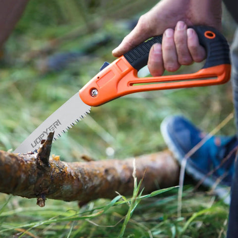 Person using 8 Inch Folding Hand Saw With Safety Guard Heavy Duty Pruning Tool For Tree Trimming And Camping High Carbon Steel With Triple Cut Razor Teeth