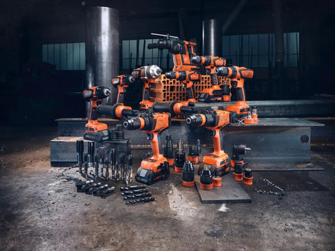 Professional Heavy Duty Compact Four Speed Cordless Drill With Brushless Motor All Metal Transmission QuickIN Adapter and rugged case arranged with various drill bits on a workshop floor.