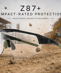 Boss Level Z87 Plus Impact Rated Safety Glasses Featuring Hella Slick Photochromic Lenses showcasing clear lenses and olive frame outdoors.