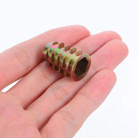 Badass Zinc Alloy Threaded Insert Nuts With Hex Socket Screws And Included Driver For Zero Sweat Furniture Assembly On Cabinets Tables Sofas And Shelves 230 Piece Go To Hardware Kit held in a hand.