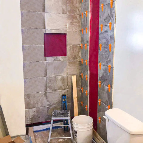 Bathroom with DIY Tile Leveling System Clips 4000 Pack for Ceramic Tile and Stone, showing 1/32 inch grout joints on wall and floor.