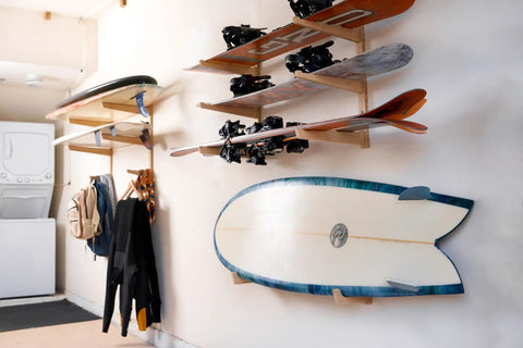 Top Shelf Heavy Duty Bamboo Ski Wall Mount Rack For Garage Storage holding skis and a surfboard on a wall with clean decor.