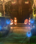 Blue Solar Torch Lights With Flickering Flames, 12 Pack Outdoor LED Tiki Torches illuminating garden pathway at night