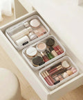 Ridiculously Tough Clear Hard Shell Zipper Cases Including Three Diaper Bag Organizer Pouches filled with makeup and toiletries in a drawer.