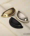 Premium Upgraded Top Shelf 3 Inch Brushed Antique Brass Cabinet Cup Pulls in three finishes on cabinet surface.