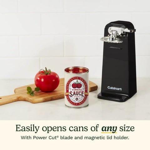 Reliable Automatic Electric Can Opener With Simple One Touch Activation And Secure Nonslip Base For No Sweat Everyday Kitchen Cooking And Canning Prep In Sleek Black next to a can of tomato sauce and a tomato.