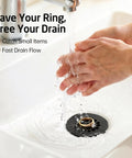 Top Tier Solid Brass Bathroom Sink Grid Drain, Hella Quick Flow Anti Clog Strainer with hand washing over black sink strainer.