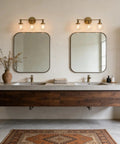 Bathroom setup with two Three Light Antique Brass Wall Sconces With Clear Glass Globes Dope Industrial Vanity Lighting above mirrors