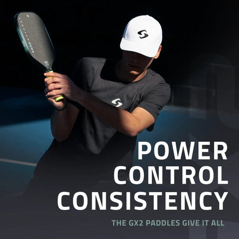Player swinging GX2 Hyper Pickleball Paddle with Aerodynamic Hyper Shape and SST 2.0 Carbon Core on tennis court.