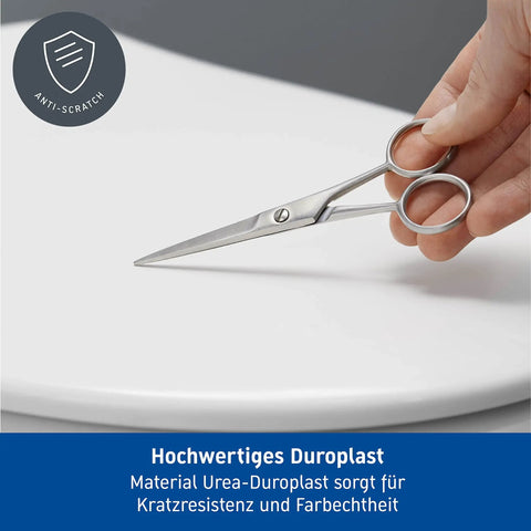 Scissors on Starck 3 Toilet Seat White High Gloss With Soft Close Lid And Stainless Steel Hinges Tool Free Removal For Quick Cleaning Durable Duroplast Construction Antistatic Water Resistant UV Resistant, demonstrating durability.