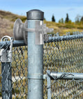 Heavy Duty Galvanized Steel Slide Rollers Built To Glide Like Butter For Chain Link Fence Gates Fits 1 7 8 Inch Posts Pack Of Two shown on gate post.
