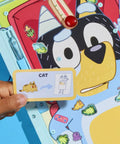 Legit Awesome Bluey Pediatrician Board Game For Kids Featuring Electronic Talking Sound Effects And All In One Carry Case With Two Play Modes And Super Chill Family Fun For Ages 6 Plus Totally Rad Interactive Playtime, showing game card with 'Cat' design.