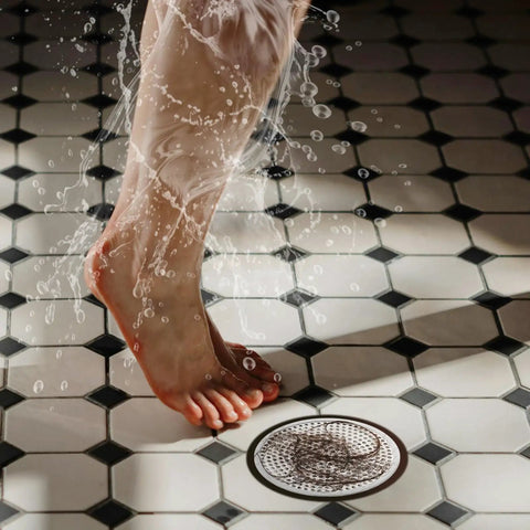 Feet standing on tiled floor near a heavy duty stainless steel strainer, Solid Build 4 Pack Shower Drain Hair Catcher With Thick Silicone Rim Heavy Duty Stainless Steel Strainer Fits 4 72 Inch Floor Drains No More Clogs Bathroom Essential Real Deal.