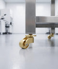 Heavy Duty Vintage Brass Swivel Caster Wheels With Cushioned Rubber Tread Set Of 4 on stainless steel furniture base.