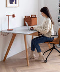 Woman seated at desk with laptop on Heavy Duty Silent Office Chair Caster Wheels Universal Threaded Stem Rollers.