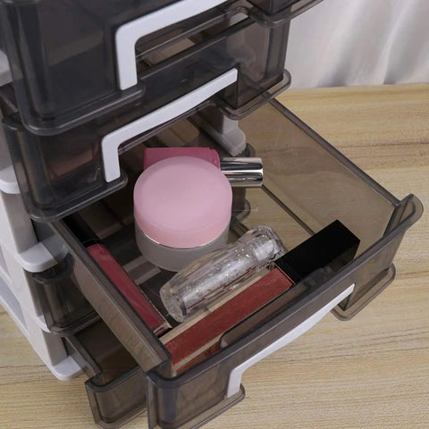 Close-up of a stacking drawer organizer box with foldable multi level design space saving storage cubes showing makeup storage.