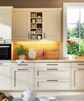 Cream kitchen cabinets with 30 Pack Solid 3-1/2 Inch Square Cabinet Handles In Oil Rubbed Bronze, showcasing replacement hardware.