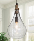 Cozy Rustic Farmhouse Wood And Glass Pendant Light with teardrop mouth-blown glass and black finish in bright kitchen area.