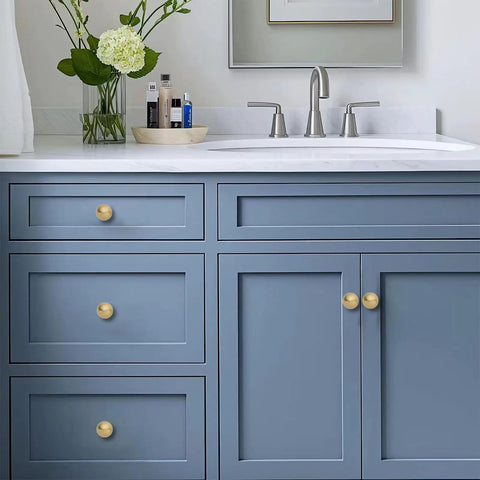 Top Shelf 10 Pack Solid Brass Cabinet Knobs Sleek Round Ball Hardware With Slick Brushed Gold Finish on bathroom vanity.