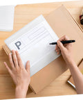 Person completing a shipping label on Epe Foam Pouches For Shipping Fragile Electronics on a cardboard box.