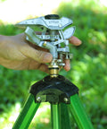 Heavy Duty Metal Impulse Sprinkler Head With Half Inch NPT Thread being installed on a tripod in a garden setting