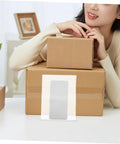 100 Pack Eva Foam Protective Bags For Shipping Delicate Cups Plates And Jewelry on stacked boxes with a person smiling.
