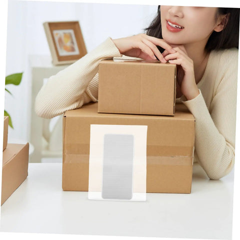 100 Pack Eva Foam Protective Bags For Shipping Delicate Cups Plates And Jewelry on stacked boxes with a person smiling.