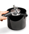 Grindenstein Espresso Knock Box Sturdy and Compact Black Coffee Grounds Container in use with hand knocking portafilter.
