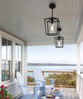 Black Farmhouse Kitchen Island Pendant Light With Metal Cage And Clear Glass Shade Giving Off Cozy Warm Vibes on porch ceiling