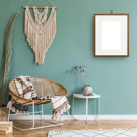 Stylish living area with wicker chair, wall art, and Bronze Stainless Steel Cubicle Wall Hooks For Fabric Panels Holds 40 Lbs