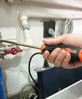 Person using 16-Piece Non-Sparking Tool Set With Screwdrivers, Adjustable Wrench, Pliers, performing maintenance on pipes