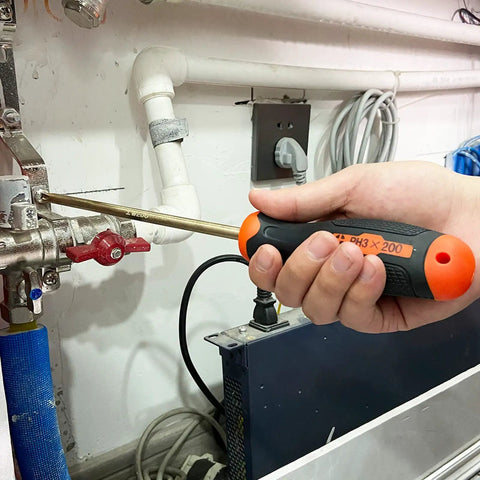 Person using 16-Piece Non-Sparking Tool Set With Screwdrivers, Adjustable Wrench, Pliers, performing maintenance on pipes