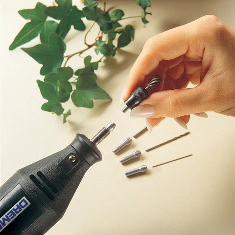 Hand holding quick change rotary tool collet nut set five piece kit with 480 481 482 483 collets and nut near Dremel tool