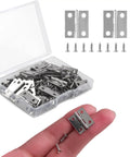 Smooth Swinging Mini Silver Hinges With Rust Resistant Iron Build And Complete Screw Set For Jewelry Boxes Dollhouses Cabinets And No Sweat Craft Room Enhancements in a hand with screws.