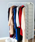Keep Your Floor Space Sick And Clean With This Hanging Shoe Organizer Bag Featuring Multi Layer Pockets And Solid Nonwoven Material Ideal For Closets Doors And Dorms To Store Every Pair Of Kicks Without Any Hassle showcasing a hanging organizer beside coats.