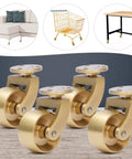 Four Pack Vintage Solid Brass Swivel Caster Wheels Built Tough Heavy Duty Ball Bearing Furniture Casters With Mounting Plates on wooden surface.
