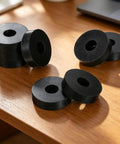 Pack of eight Heavy Duty Rubber Isolation Mounts And Anti Vibration Pads Built Mean To Crush Appliance Rattle on wood surface.