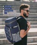 Man carrying blue 35 Can Leakproof Insulated Cooler Backpack For Beach Camping Kayaking And Hiking, Soft Ice Chest Bag on steps