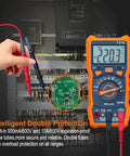 Auto Ranging Pro Grade Digital Multimeter With TRMS 6000 Counts measuring voltage in an electrical panel, orange shell visible.