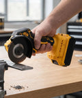 Close-up of Badass Precise Brushless Mini Circular Saw Sweet Cordless Angle Grinder Hybrid cutting a metal pipe with sparks.