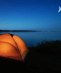 Illuminated tent by a lakeside under crescent moon, perfect setting for using a 2-Cell CR123 LED Tactical Flashlight With High-Brightness Beam