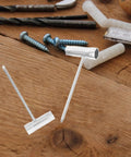 Heavy Duty Four Piece Chainsaw Wrench Socket Set With Bar Adjustment Tool on wooden surface, showcasing two metal tools.