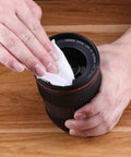 Person using Premoistened Screen Cleaning Wipes For Electronics And Devices No Mess Easy Cleanup on camera lens