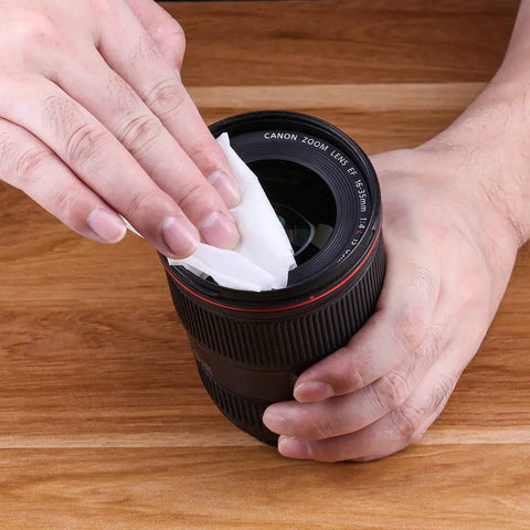 Person using Premoistened Screen Cleaning Wipes For Electronics And Devices No Mess Easy Cleanup on camera lens