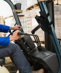 Rugged Barcode Scanner Holster With Ballistic Nylon Carrying Case For MC3300 attached to forklift, in warehouse setting.
