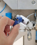 A hand holding a blue lever of Heavy Duty Brass Pneumatic Mini Ball Valve Shut Off With Npt 1/4 Inch Threads For Smooth Garden And Home Plumbing Pipe Control No Sweat Install Durability.